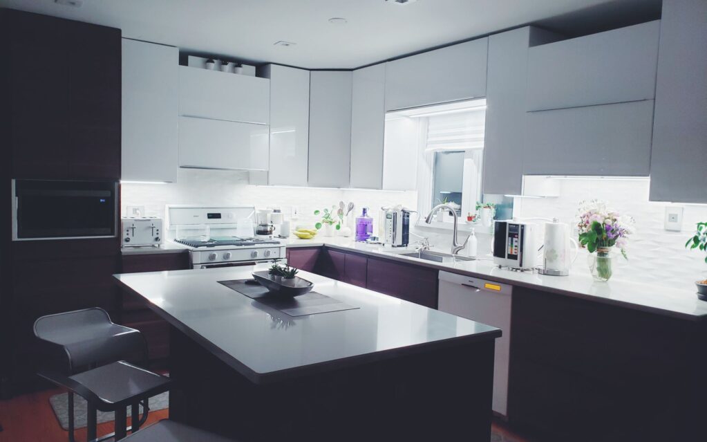 Contemporary kitchen with sleek cabinets and an island - kitchen and bath, Somerville