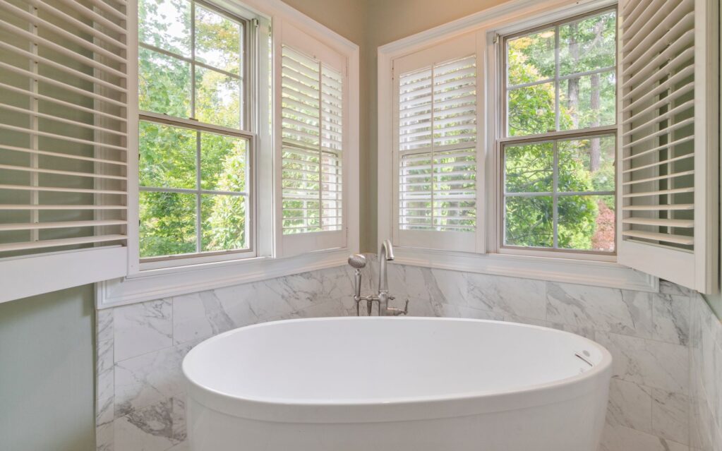 Bathroom with a marble tub under a bay window - kitchen and bath, The Chathams