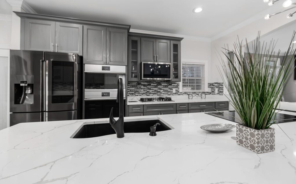 Kitchen with white countertops and a black sink - kitchen and bath, Watchung Hills