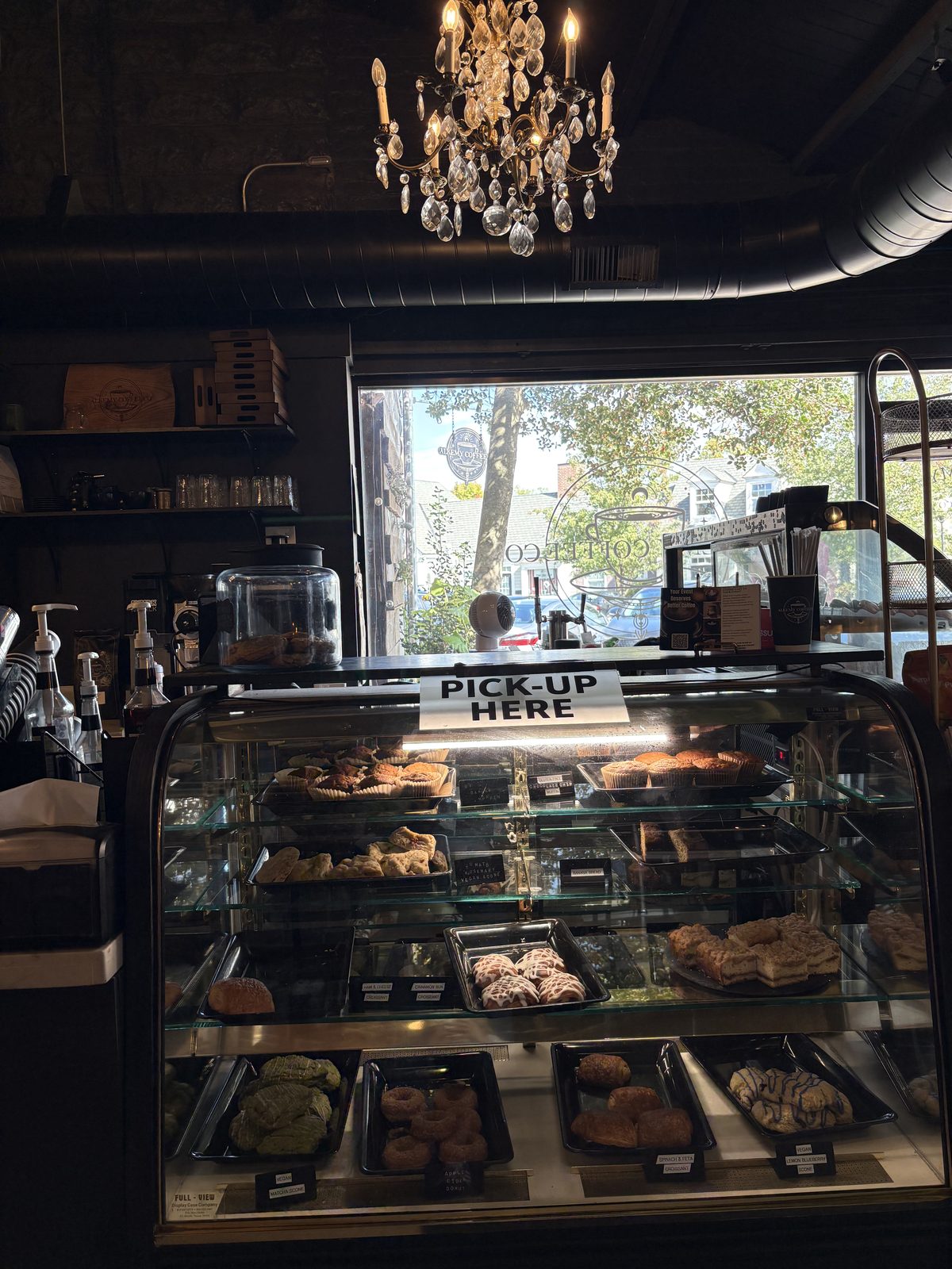 Alkemy Coffee Co., Flemington - the pastry case with scones and pastries under a chandelier