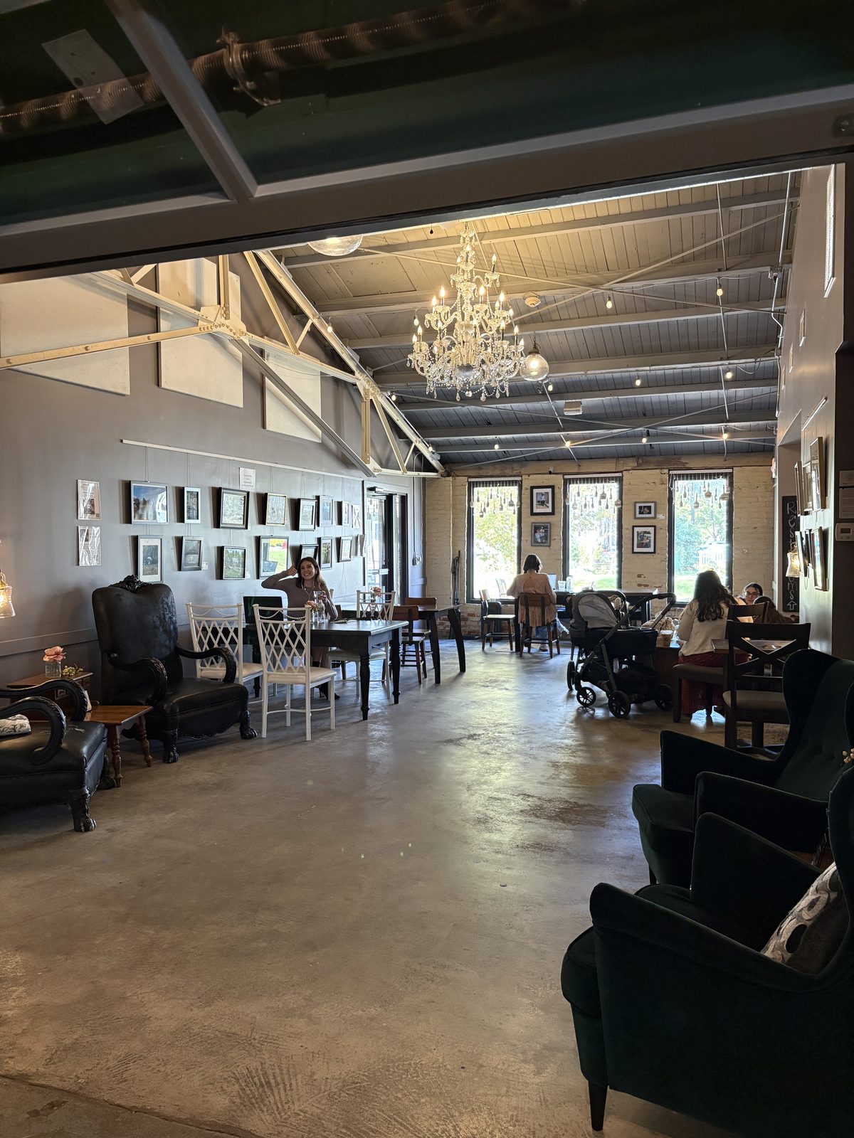 Alkemy Coffee Co., Flemington - the large seating room with armchairs, a chandelier and gallery walls