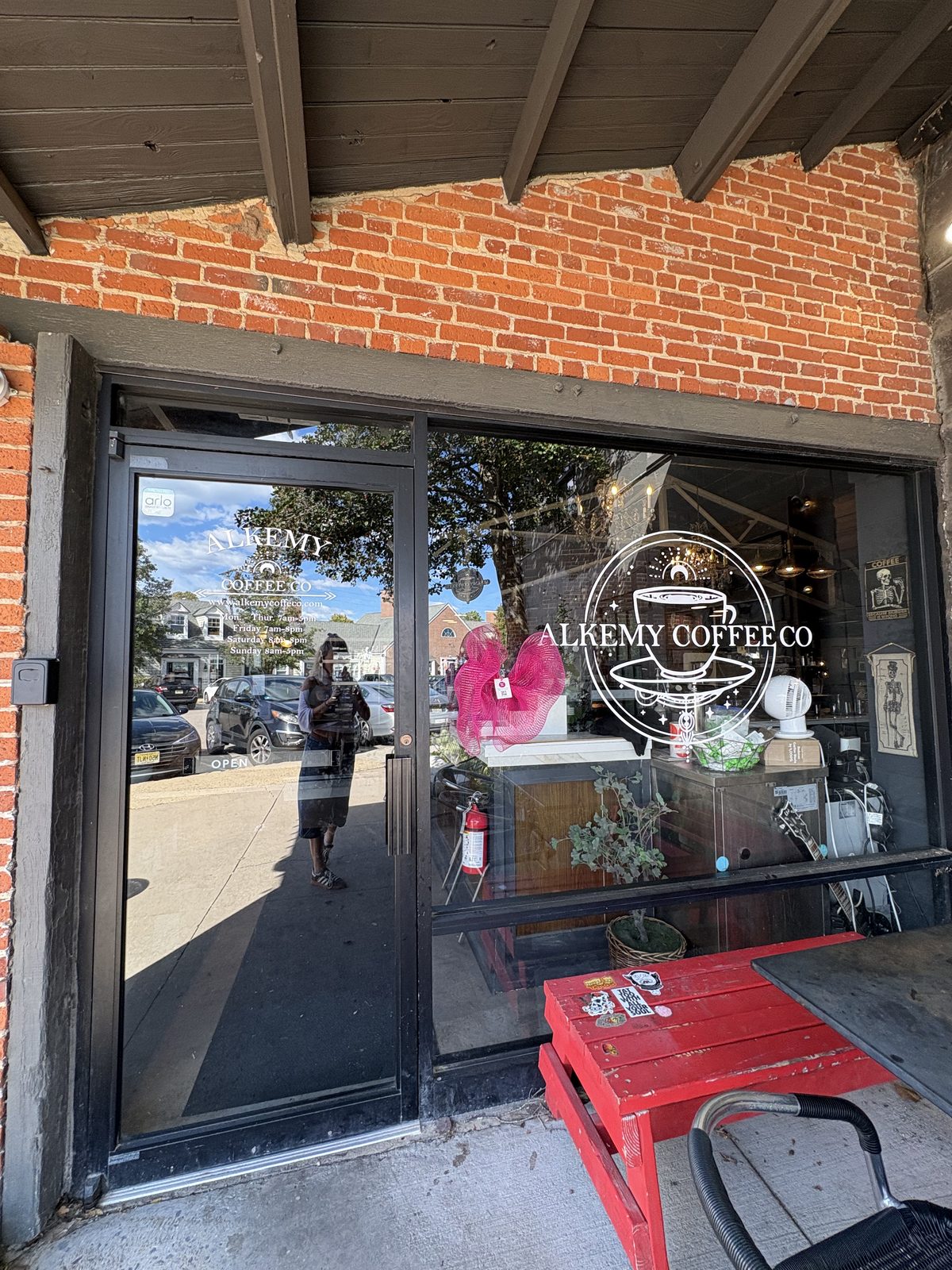 Alkemy Coffee Co., Flemington - the brick storefront with glass doors and a red wooden pallet seat out front