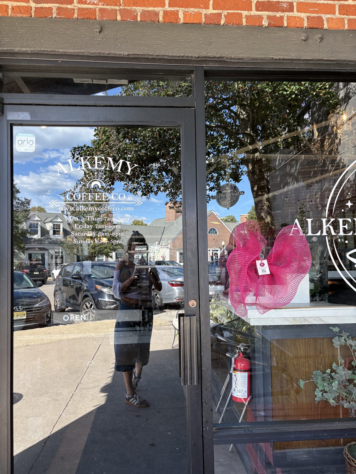 Alkemy Coffee Co., Flemington - the glass door with the Alkemy logo and a hours decal
