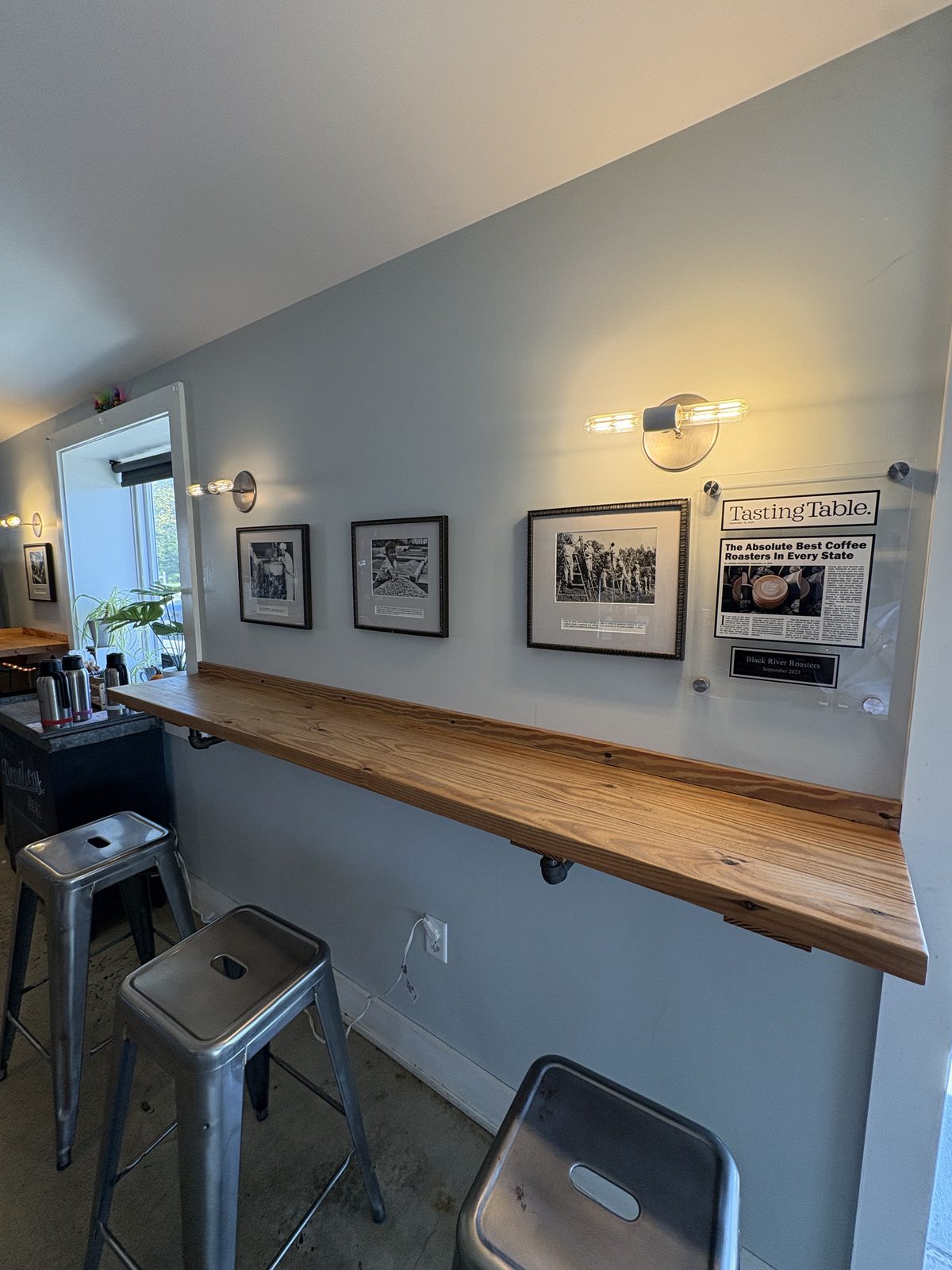 Black River Roasters, Whitehouse Station - a window-side bar with metal stools and framed black-and-white photos