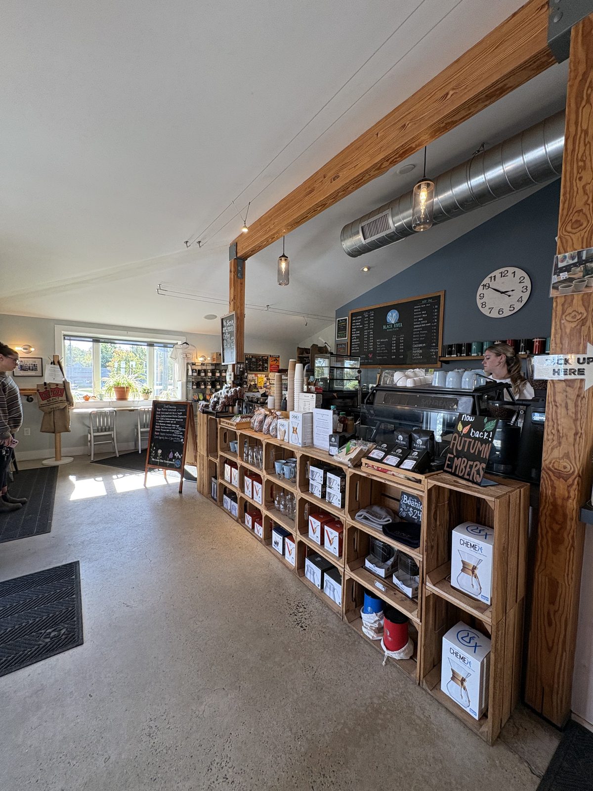 Black River Roasters, Whitehouse Station - the shop floor with a wood crate shelf of coffee gear and the counter at the back