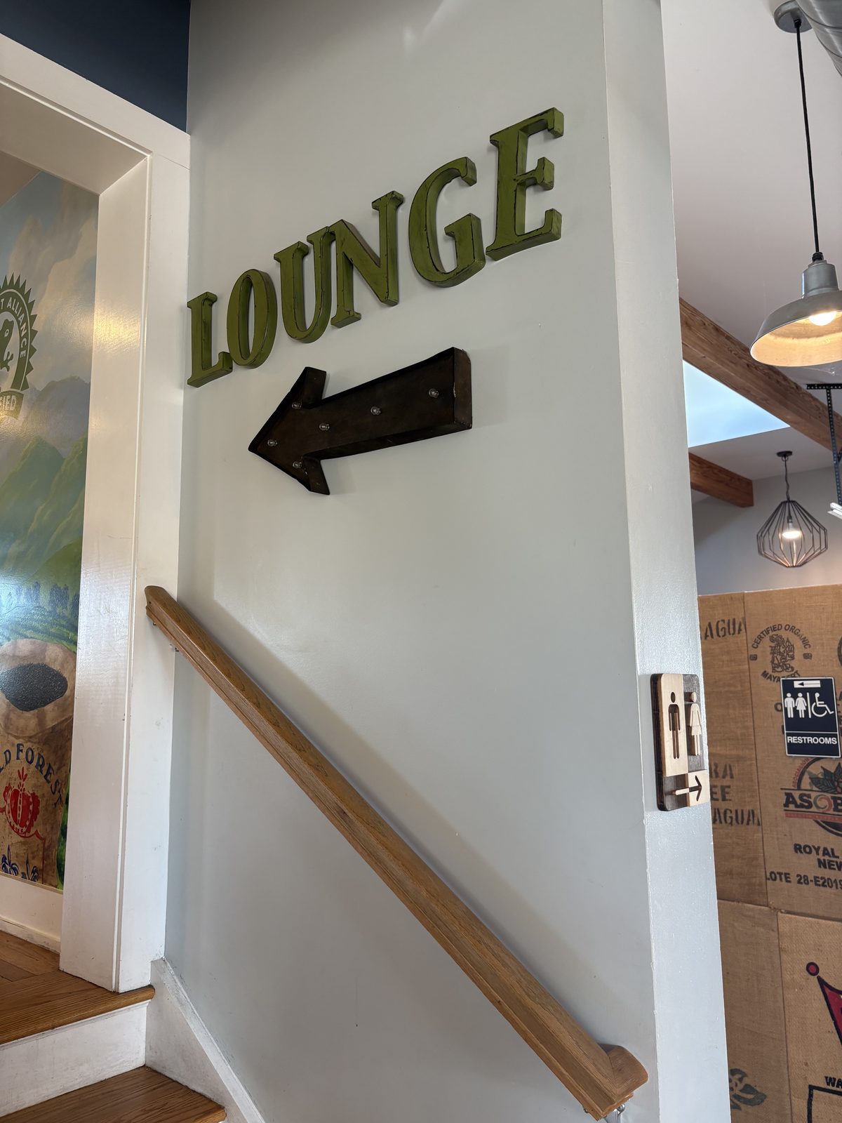 Black River Roasters, Whitehouse Station - a Lounge sign with an arrow at the top of the stairs