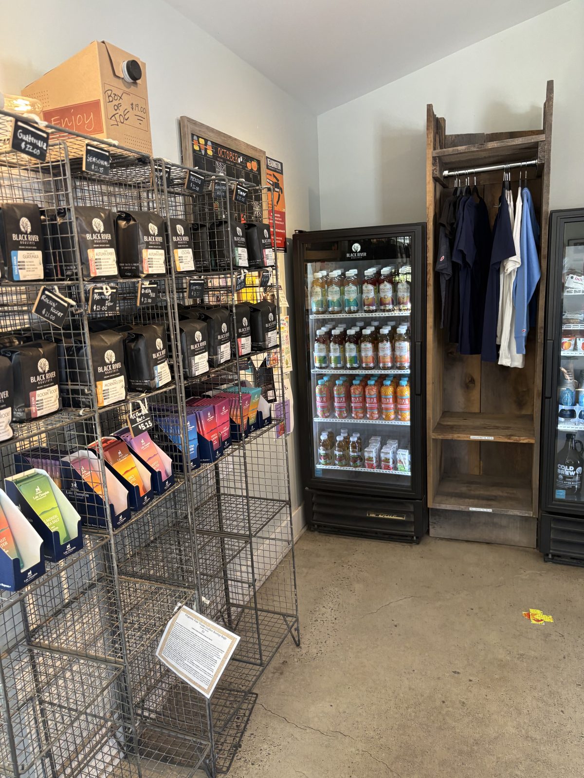 Black River Roasters, Whitehouse Station - racks of bagged Black River coffee beside a cold drink cooler