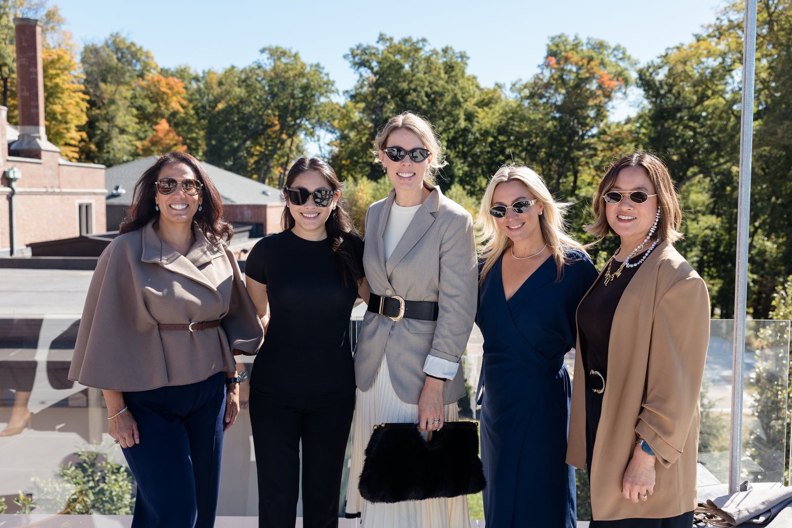 Boardrooms & Brunch, Pendry Natirar, Oct 9 2026 - five guests posing on a terrace with autumn trees behind them