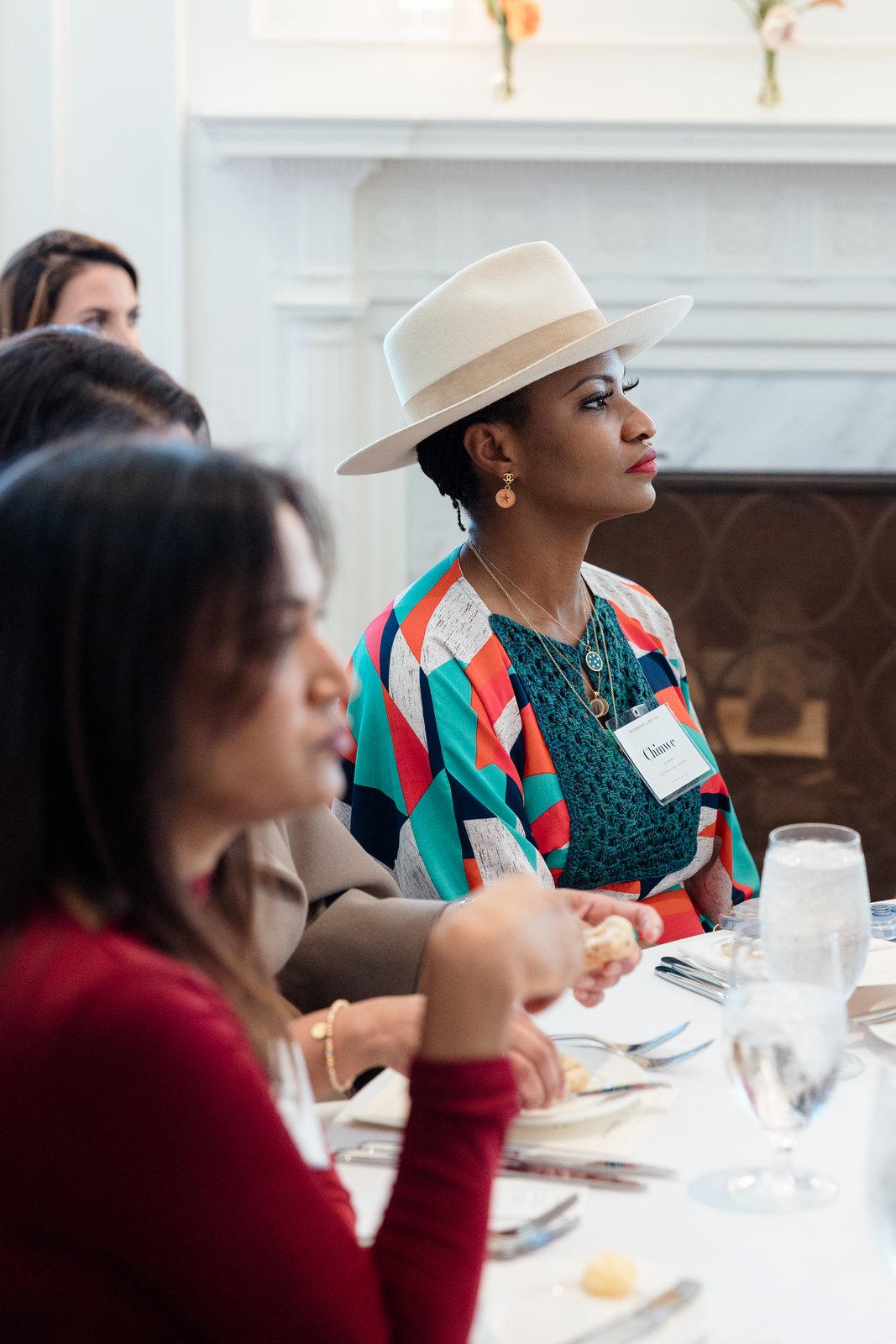 Boardrooms & Brunch, Pendry Natirar, Oct 9 2026 - a guest in a patterned top seated at a luncheon table beside a fireplace