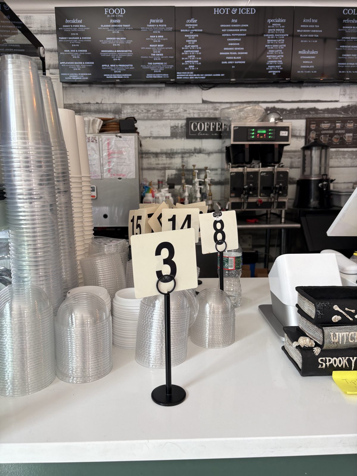 Jimmy's Coffeehouse, Clinton - the menu boards, cup stacks and a table number stand at the counter
