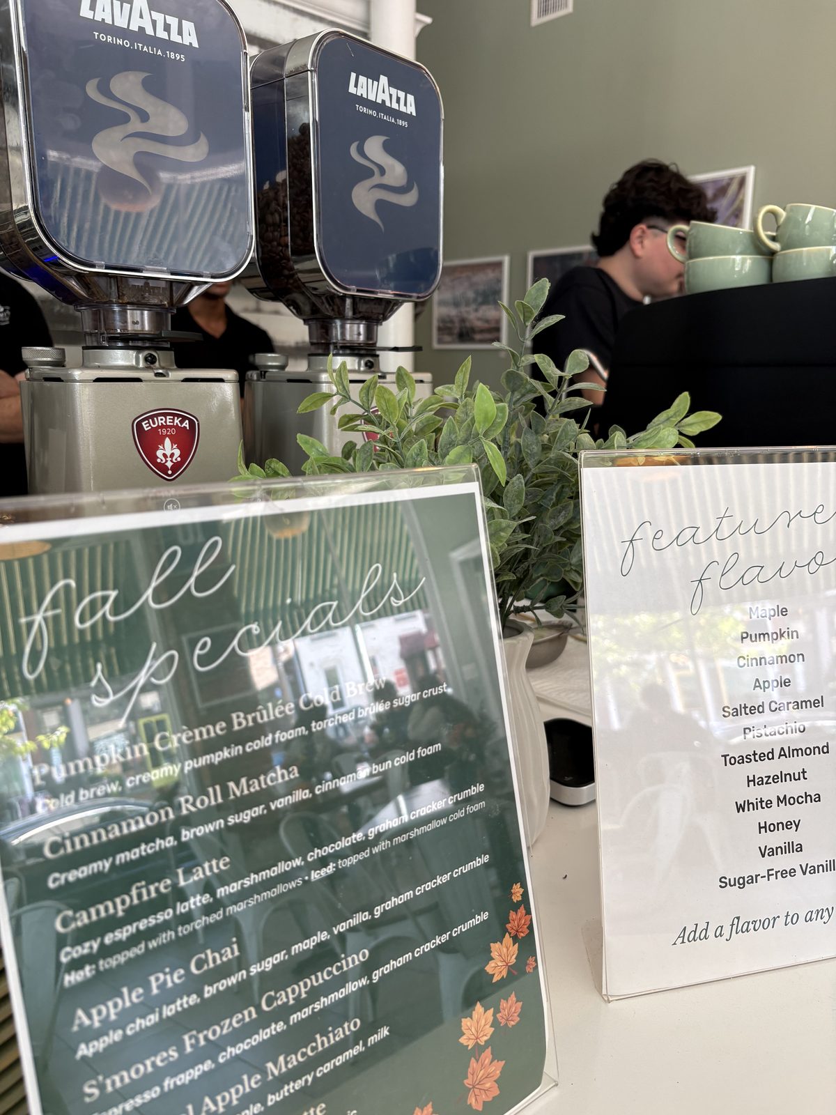 Jimmy's Coffeehouse, Clinton - fall specials and feature flavors menus on the counter with a barista behind