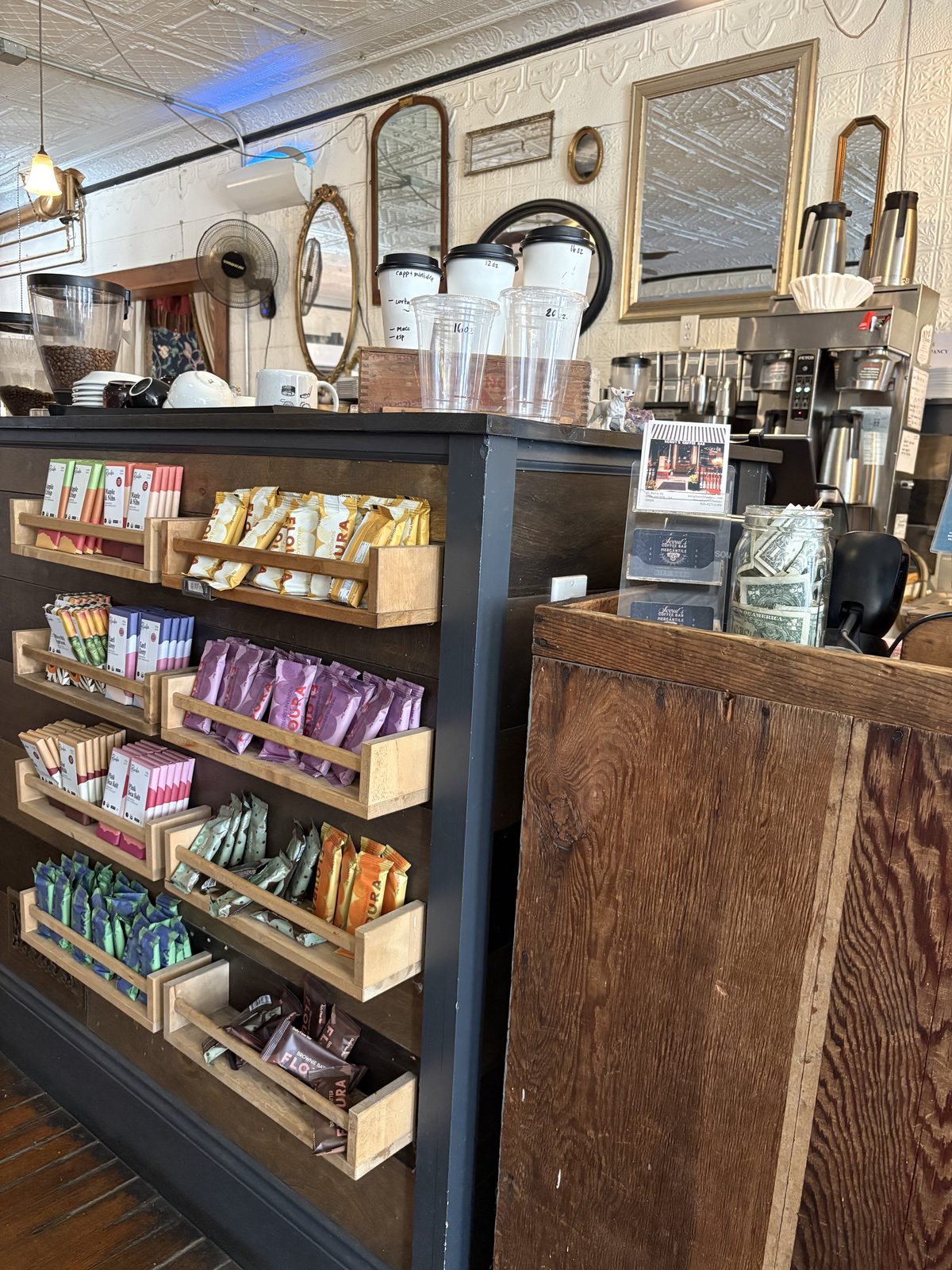 Scout's Coffee Bar + Mercantile, High Bridge - the counter front with shelves of chocolate bars and coffee bags for sale