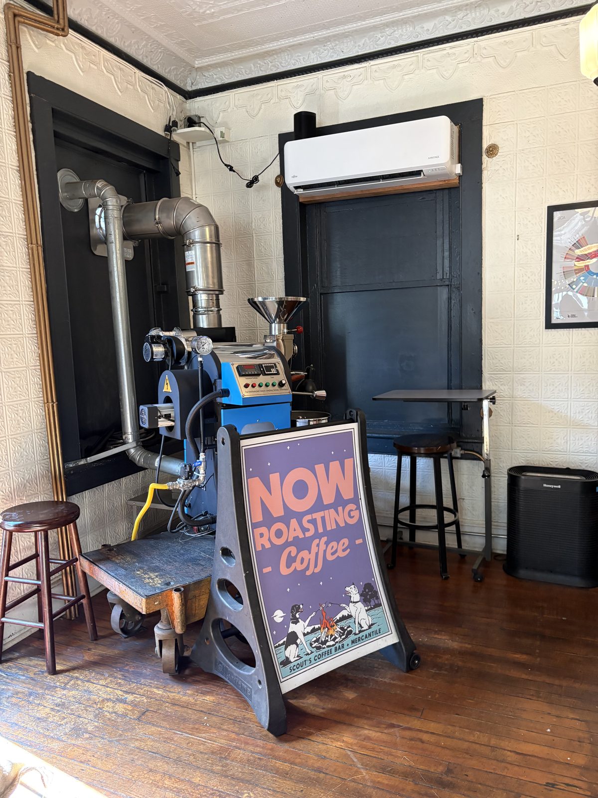 Scout's Coffee Bar + Mercantile, High Bridge - the coffee roaster on the floor with a Now Roasting Coffee sign