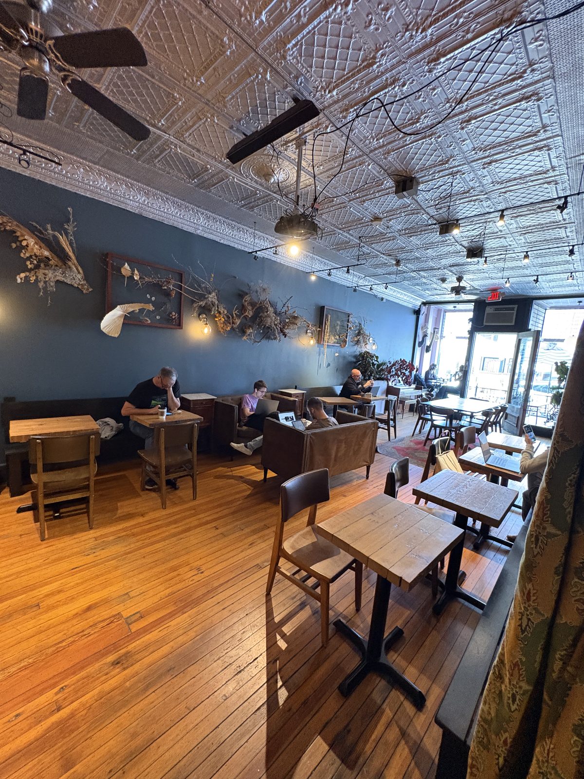 Scout's Coffee Bar + Mercantile, High Bridge - the front room with wood tables, couches and customers at laptops