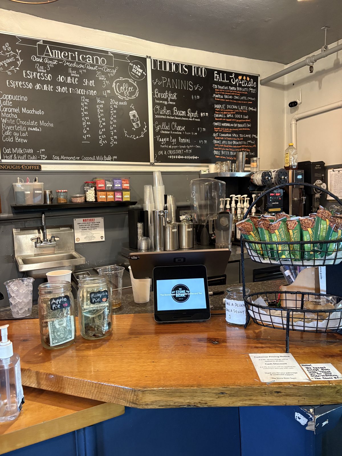 The Stone Bean, Clinton - the counter with chalkboard menus, tip jars and a register